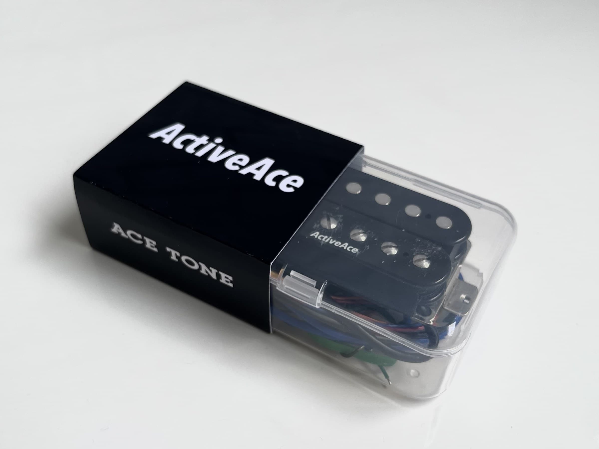 ActiveAce retail packaging, showing the ActiveAce mark on the face and the ACE TONE mark on the side, with the pickup visible through the clear case
