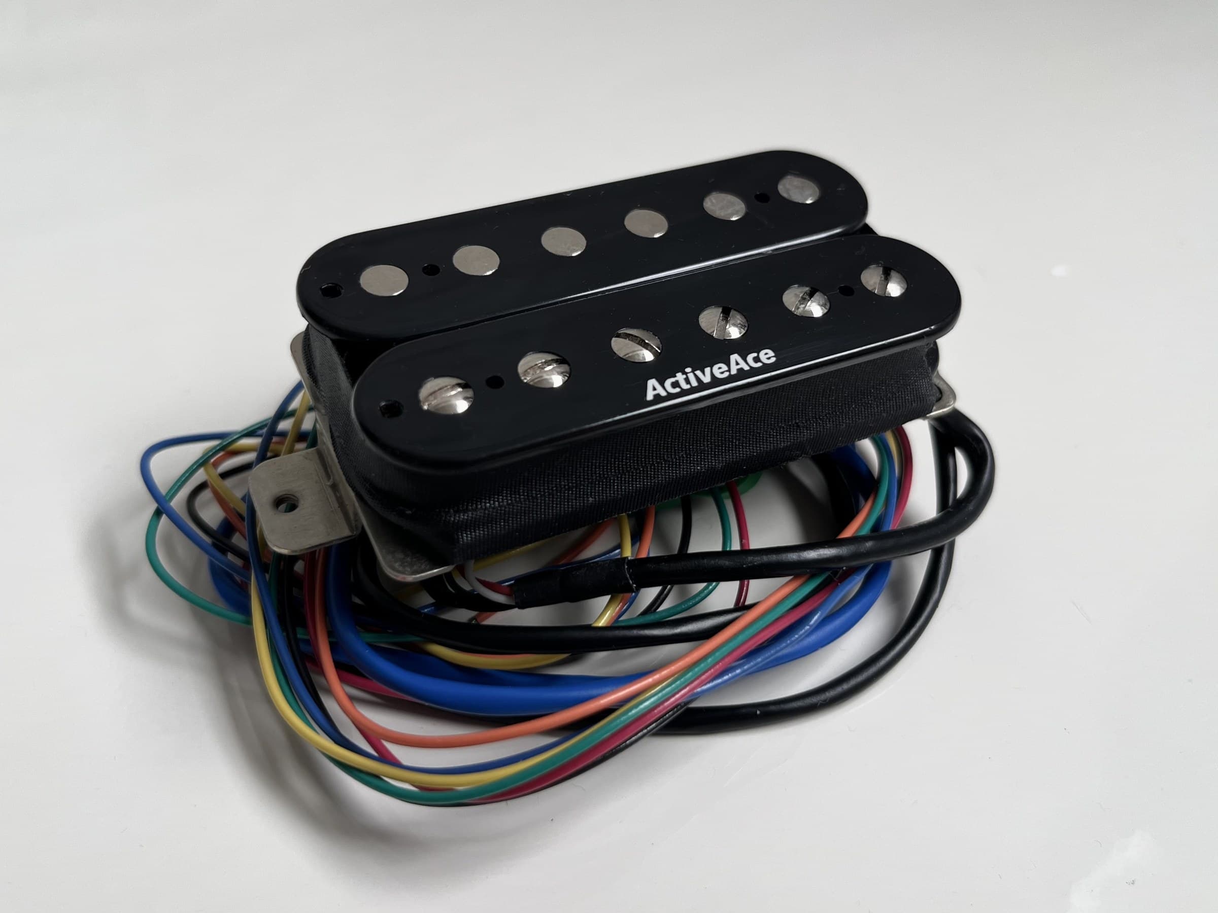 ActiveAce humbucker pickup with its wiring loom, the ActiveAce mark printed on the bobbin